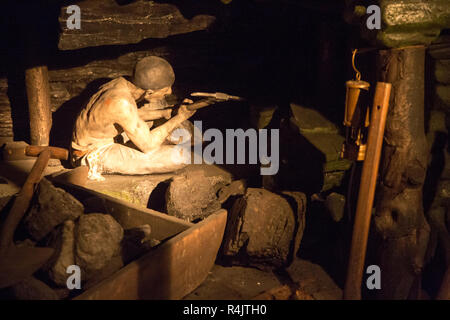Coal mining display, miner at coalface using hand pick, Radstock museum, Somerset, England, UK Stock Photo