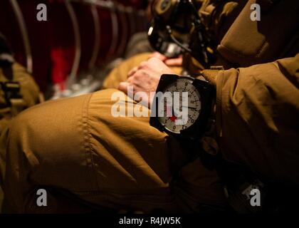 U.S. Marines fly aboard a KC-130J Super Hercules during Exercise Trident Juncture 18 near Vaernes Air Base, Norway, Oct. 31, 2018. The exercise enhances the U.S. and NATO Allies’ and partners’ abilities to work together collectively to conduct military operations under challenging conditions. The Marines are with 2nd Reconnaissance Battalion, 2nd Marine Division, and the KC-130J is with Marine Aerial Refueler Transport Squadron 252, 2nd Marine Aircraft Wing. Stock Photo