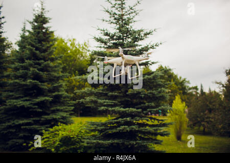 UFA, RUSSIA - 11 JULY 2018: Drone DJI Phantom 4. Quadrocopter against the blue sky with white clouds. Stock Photo