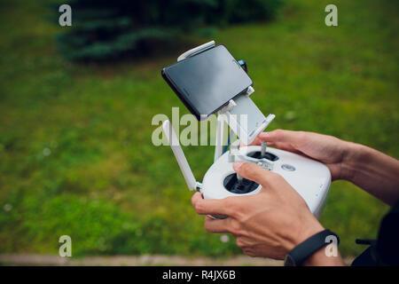 UFA, RUSSIA - 11 JULY 2018: Drone DJI Phantom 4. Quadrocopter against the blue sky with white clouds. Stock Photo