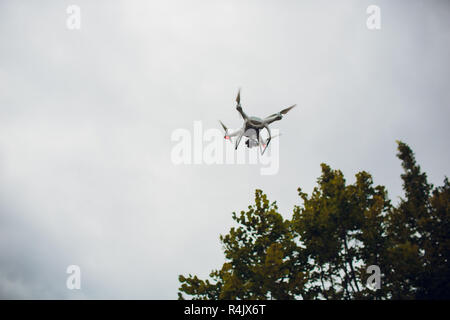 UFA, RUSSIA - 11 JULY 2018: Drone DJI Phantom 4. Quadrocopter against the blue sky with white clouds. Stock Photo