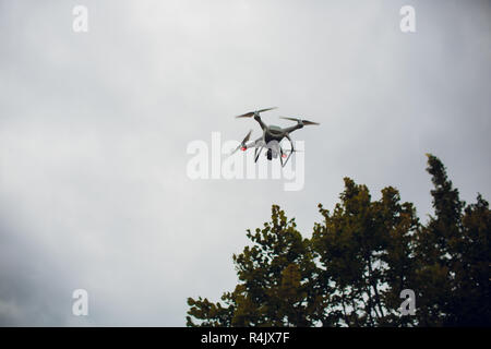 UFA, RUSSIA - 11 JULY 2018: Drone DJI Phantom 4. Quadrocopter against the blue sky with white clouds. Stock Photo