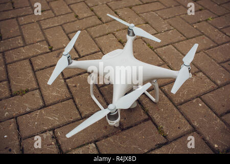 UFA, RUSSIA - 11 JULY 2018: Drone DJI Phantom 4. Quadrocopter against the blue sky with white clouds. Stock Photo