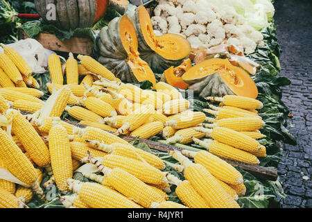 Turkish farmer market. Heap of fresh organic vegetables on the counter cauliflower, corn cobs, greens, sliced pumpkins. Stock Photo
