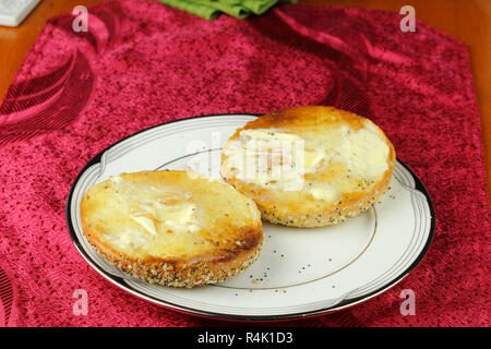 Toasted and Buttered Everything Bagel on a Plate Stock Photo