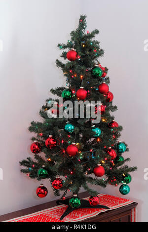Small Christmas Tree on a Bureau in a Corner Stock Photo