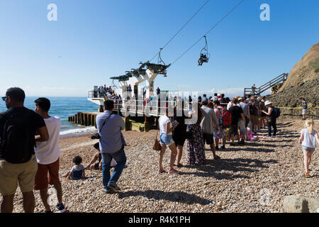 Tourists and visitors queueing / queue at the Needles Chairlift terminal station on the beach below Alum Bay Cliffs. Chairlift takes visitors to the beach & the bay. Isle of Wight. UK (98) Stock Photo