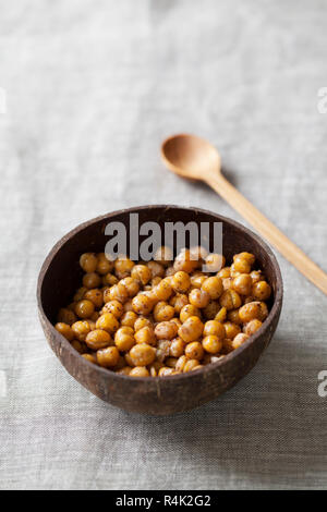 Spicy roasted chickpeas in coconut bowl Stock Photo