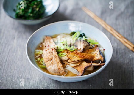 Miso ramen with king oyster mushrooms, salmon and rice noodles Stock Photo