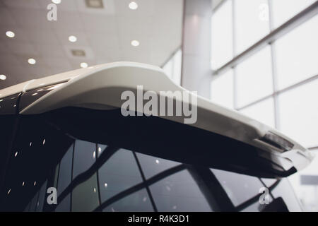 rear window of the car, spoiler with brake light in raindrops. Stock Photo