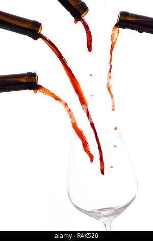 Red wine poured by many bottle in a empty wine glass Stock Photo