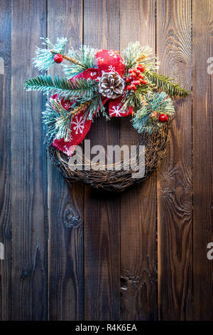 Christmas wreath on a rustic wooden door. Stock Photo