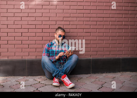 Handsome hipster guy working on digital tablet. Stock Photo