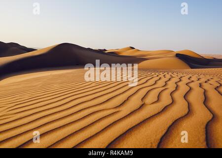 Sand dunes in desert landscape. Wahiba Sands, Sultanate of Oman. Stock Photo