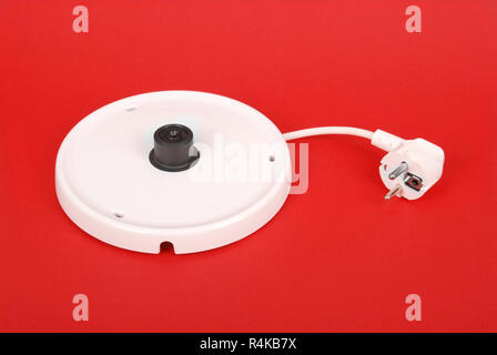 Base unit for electrical kettle isolated on the red background Stock Photo