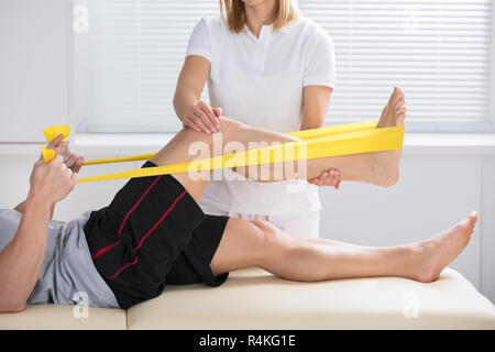 Physiotherapist Giving Treatment With Exercise Band Stock Photo