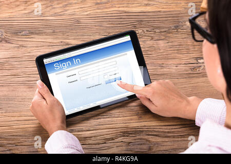 Businesswoman Login On Digital Tablet Stock Photo
