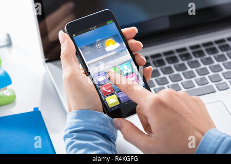 Woman Using Smart Phone With Applications On Screen Stock Photo