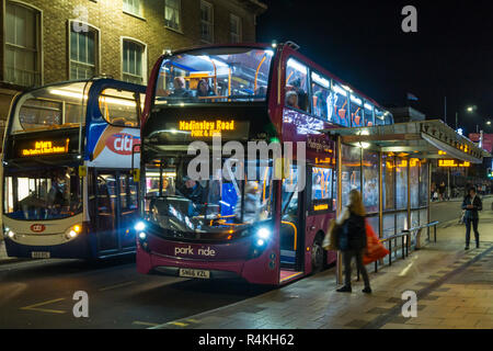 A Park & Ride bus at a bus stop in Cambridge at night. Stock Photo