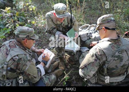 A group of U.S. Army Pre-Ranger Students, looks over the route to the objecive on a map during Pre-Ranger School at Training Area Echo, Fort Benning, GA., October 28, 2018. Pre-Ranger School provides guidance and mentorship for students to be successful as they prepare to attend Ranger School. Stock Photo