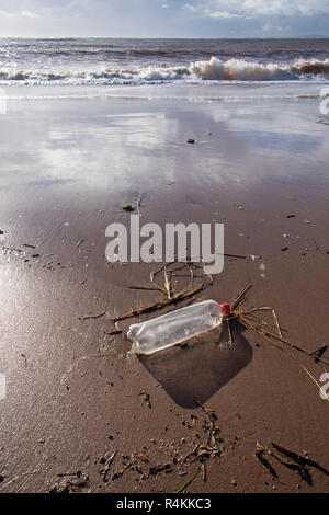 Plastic bottle washed  up on Exmouth beach, Devon, UK Stock Photo