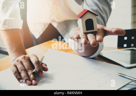 Architect or engineer using pen working on blueprint, architectural concept Stock Photo