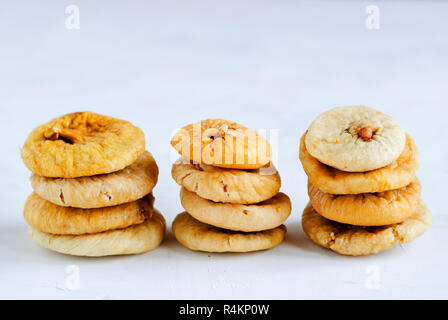 Composition of stacked piles of delicious sweet dried figs on white background Stock Photo
