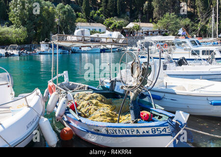 Small fishing boat moored at the pretty coastal village of Kouloura in Corfu Stock Photo