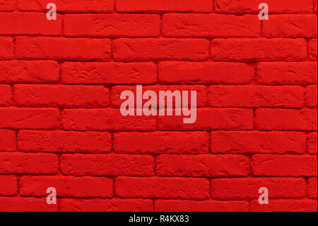 red brick wall painted at saturated scarlet colour. closeup texture background Stock Photo