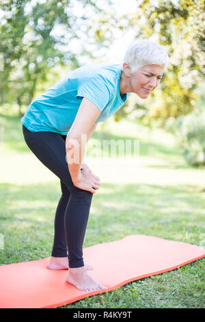 Senior sporty woman has  knee pain while workout Stock Photo