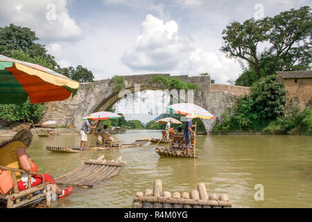 Yangshuo, China - July 14, 2010: Traditional bamboo raft on Yulong River, Yangshuo, Guangxi, China. The most popular way to enjoy the scenery of the Y Stock Photo