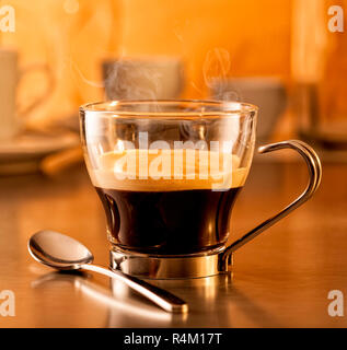 Hot steaming espresso coffee in a glass cup Stock Photo