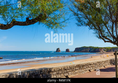 HENDAYE, FRANCE - JUNE 8: Tourists and surfers enjoy the beach of the charming seaside resort of Hendaye on June 8, 2017. Hendaye is located in the Py Stock Photo