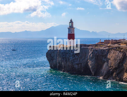 Lighthouse of Europa Point in Gibraltar overlooking the Strait with Morocco in background. Stock Photo