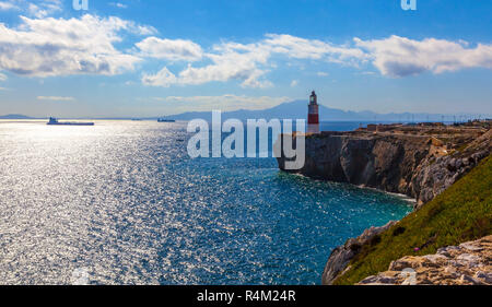 Lighthouse of Europa Point in Gibraltar overlooking the Strait with Morocco in background. Stock Photo