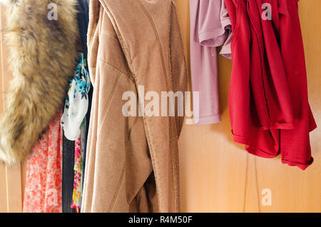 Pile of carelessly scattered clothes in wardrobe Stock Photo