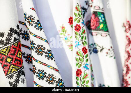 Close-up Romanian traditional embroidery on costumes. Close up of traditional Ie Romanian clothing. Stock Photo