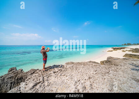 A tourist explores Santa Carolina Island, Bazaruto archipelago Mozambique. Stock Photo