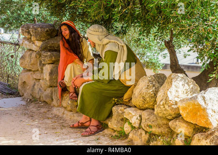 A young man and woman in period costume in the open air museum of Nazareth Village Israel. This site provides a look at  ancient Israel Stock Photo