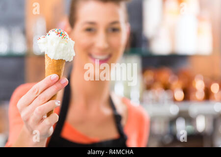 Female seller in Parlor with ice cream cone Stock Photo