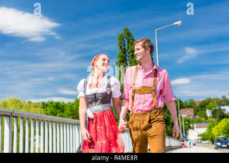 Couple visiting Bavarian fair having fun Stock Photo