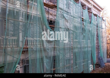 Construction site restoration work on the renovation of the old facade of the building of Soviet times. Stock Photo