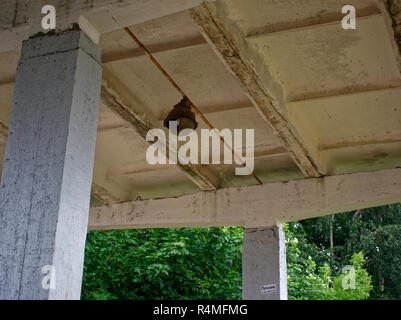 broken light bulb on the ceiling of the railway station, Russia Stock Photo