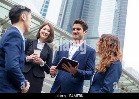 Group of business people discuss on digital tablet Stock Photo
