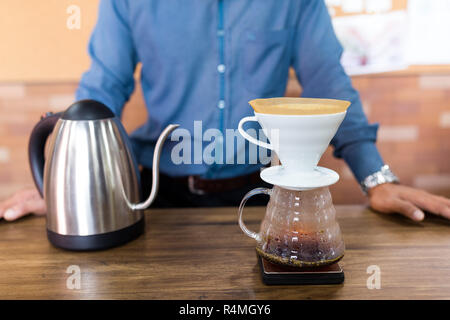 Male Barista making of coffee in cafe Stock Photo