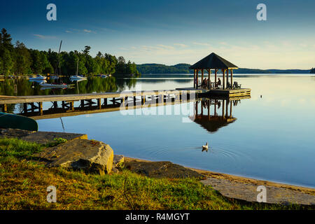 People enjoying the sunset at a boat dock on Lake of Bays in Dwight, Ontario,Canada, North America Stock Photo