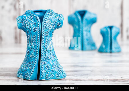 Turkish Handmade  Symbolic Ceramic Figurines on White Wooden Background Stock Photo