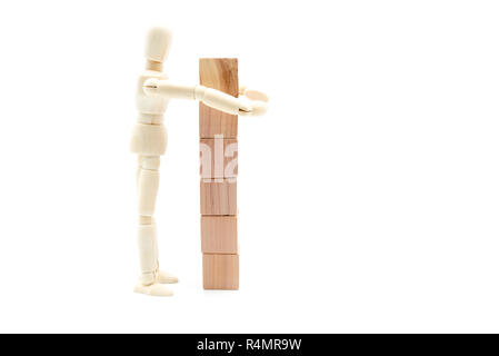Wooden figure as businessman building tower of wood cubes, isolated on white background, minimalist concept Stock Photo