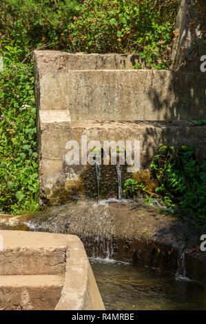 In a concrete channel guided Levada, inflow of water through two holes in the concrete, Madeira Stock Photo