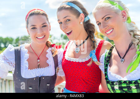 Friends visiting Bavarian fair having fun Stock Photo